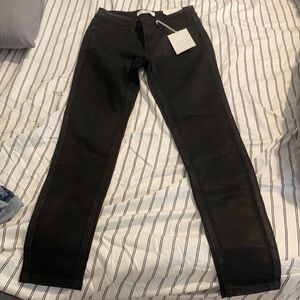 Black jeans that have a shiny finish. New worn with tags